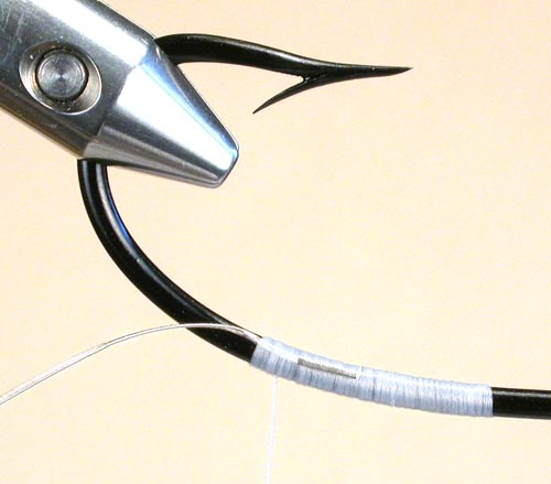 Step 4 This shows the tip tie in on the back side of the hook at about the 5:20 position and tug it into about 5:25 when applying the tip. Finish the tip and tie off just above the tie in area of the tip